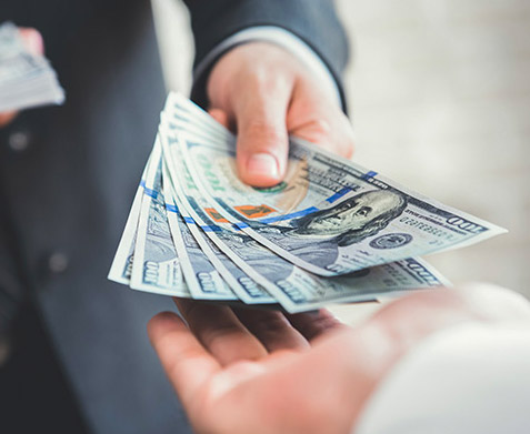 Stack of money being handed over