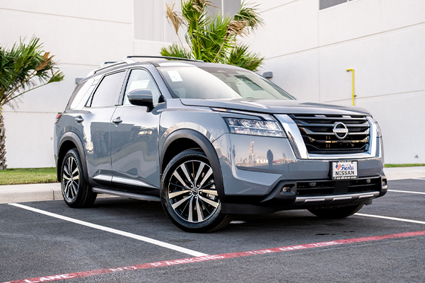 3/4 profile view of a new Nissan SUV parked outside on a nice day