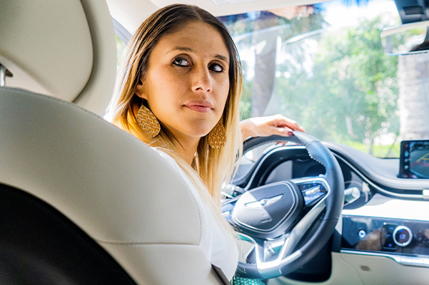 woman sitting inside her new genesis