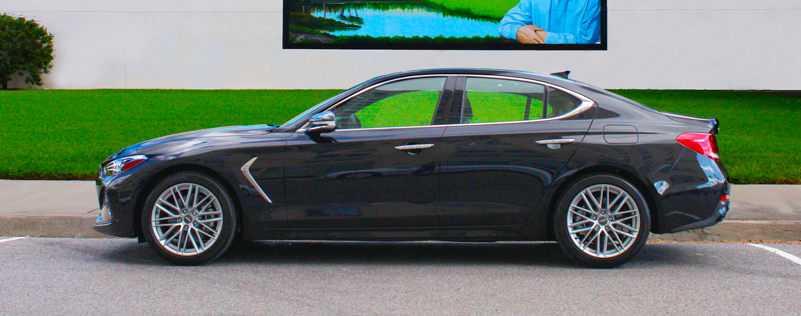 new genesis parked in front of a building