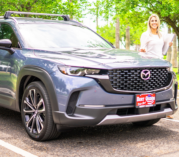 Woman standing beside a Bert Ogden Vehicle
