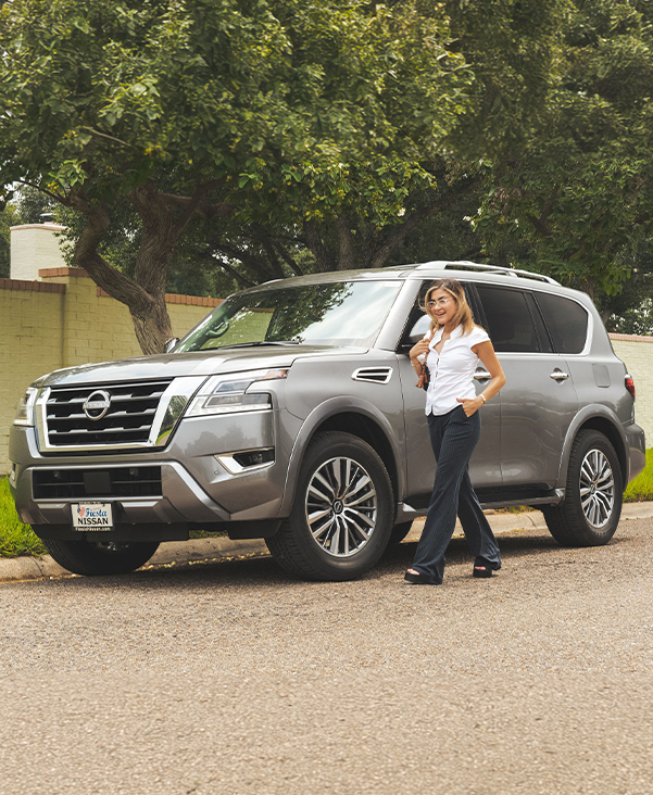 Woman walking beside a new Bert Ogden Nissan