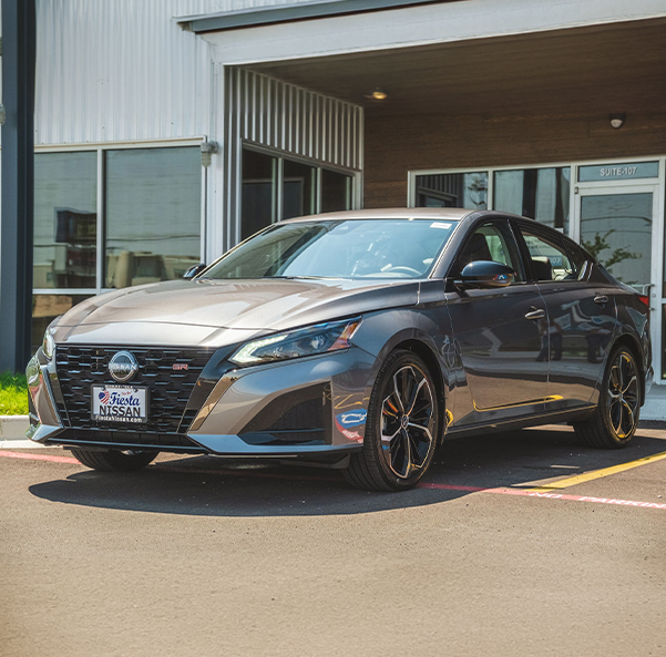 Bert Ogden Nissan parked in front of the dealership