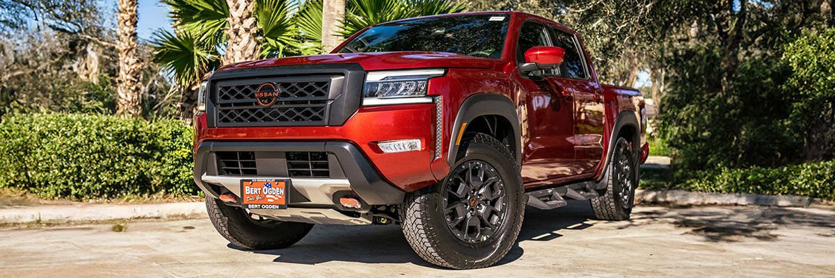 Bert Ogden Nissan Truck parked in front of palm trees