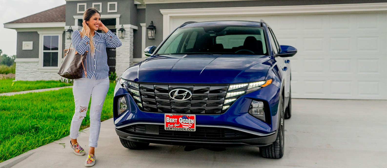 happy person walking around the front of their new hyundai