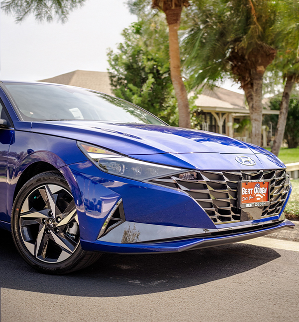 Cropped view of a blue Hyundai parked outside