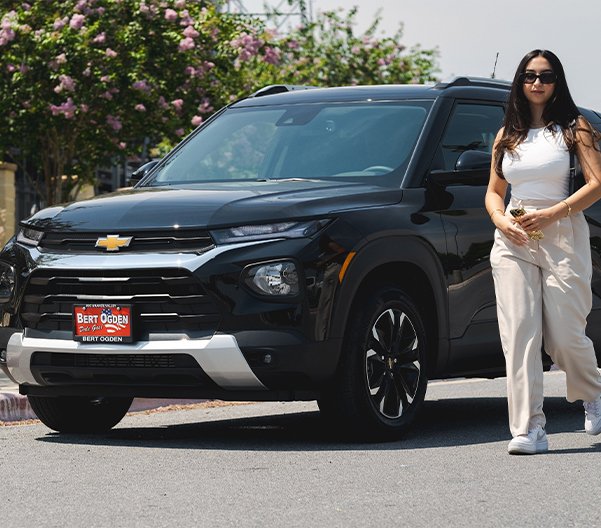 Woman walking beside a Bert Ogden chevy
