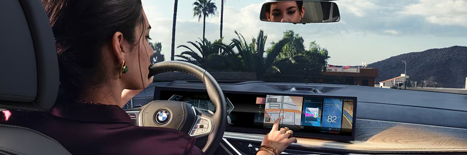Woman using the interface in her BMW SUV