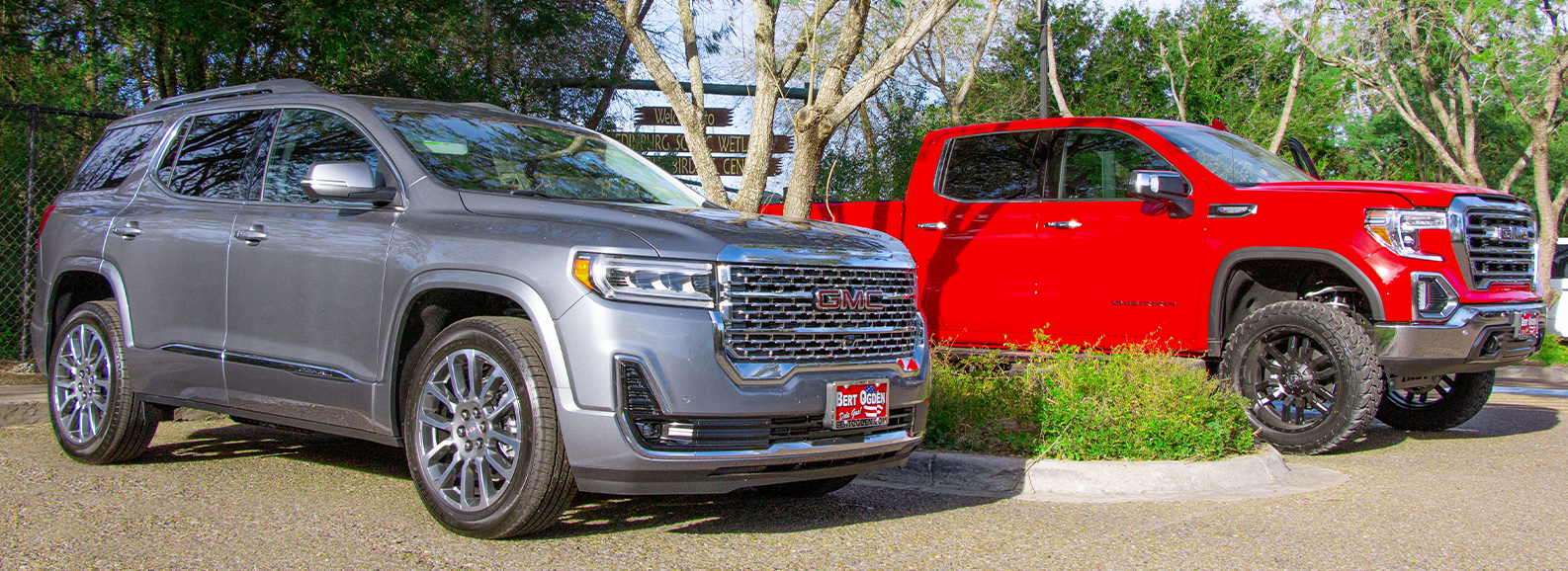 new GMC models parked in a parking lot on a nice day