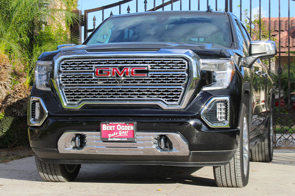 GMC Sierra 1500 parked in front of a gate