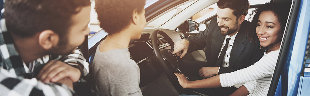 Family checking out a new car