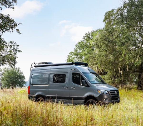 A Mercedes-Benz Metris van in a field