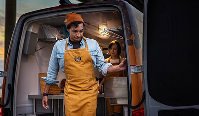 A catering business owner unloading his Mercedes-Benz Sprinter Van.