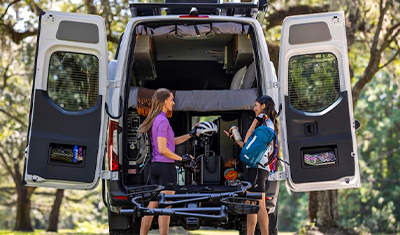 View of a Mercedes-Benz Sprinter Van, back open.