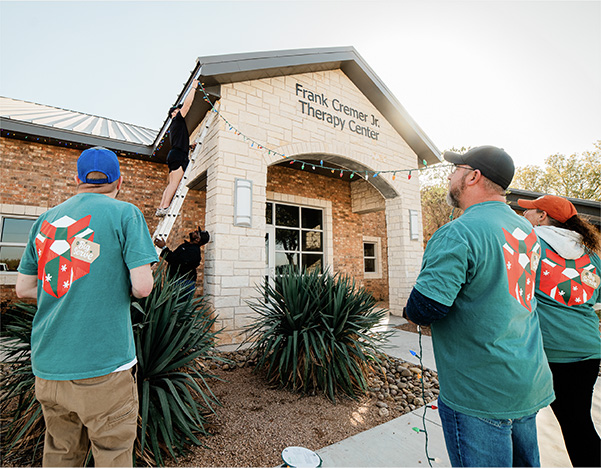 Action shot of dealership employees helping in the community